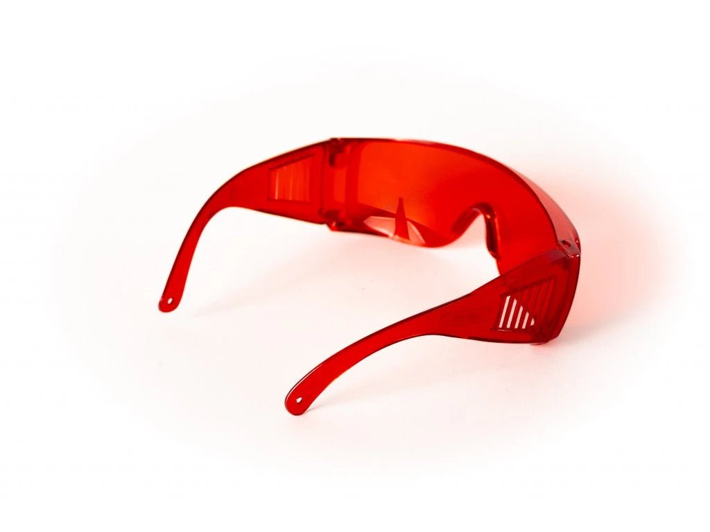 Red glasses against blue and green light - LifeUnlocked